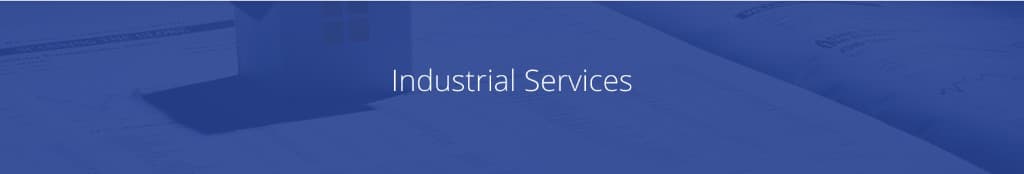 Documents and property materials with a small architectural model, representing industrial real estate services