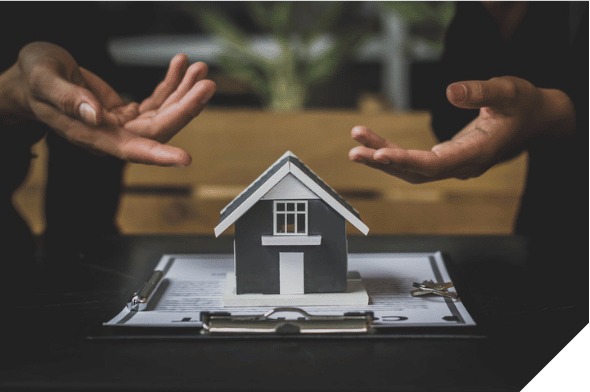 Hands presenting a small house model over a lease document