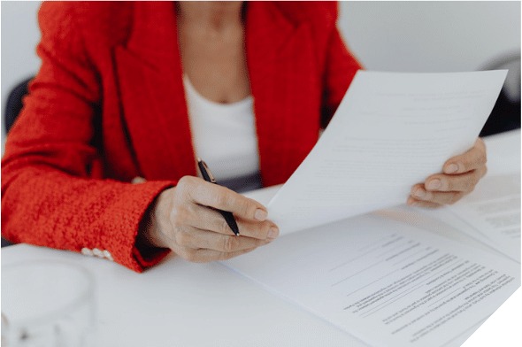 A woman in a red blazer reviewing a property document